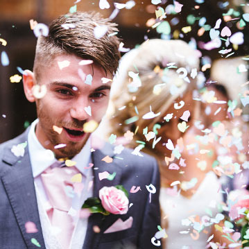 Confetti Sprinkled Over Married Couple
